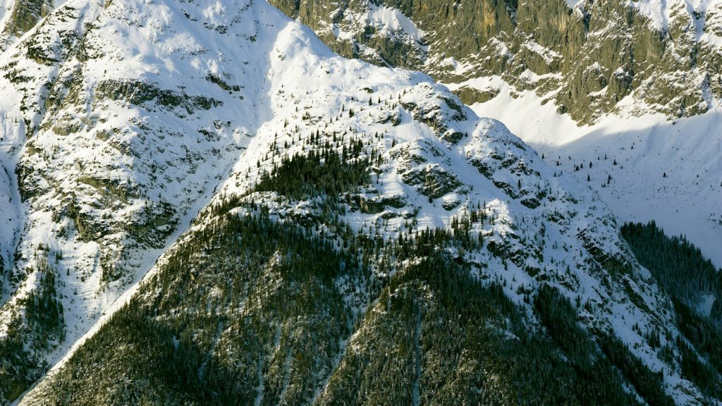 An aerial view of a mountain range covered in snow
