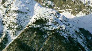 An aerial view of a mountain range covered in snow